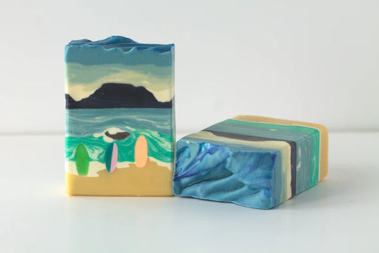 Two soap bars with artistic designs on a white background