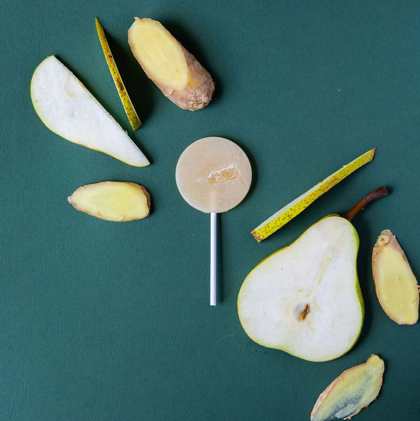 Sliced pears and ginger on a green background